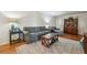 Living room with hardwood floors and a comfortable seating area with grey sofa and love seat at 4730 Geneva Sw Dr, Lilburn, GA 30047