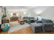 Open-concept living room and dining area features hardwood floors and large windows at 4730 Geneva Sw Dr, Lilburn, GA 30047