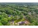 Picturesque aerial view reveals the home nestled among trees with a backdrop of dense forest at 4840 Moon Rd, Powder Springs, GA 30127