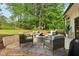 Cozy backyard patio seating area with a stone fire pit and gravel landscaping at 4840 Moon Rd, Powder Springs, GA 30127