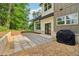 Exterior of the home with backyard patio, gravel landscaping, and a black grill at 4840 Moon Rd, Powder Springs, GA 30127