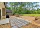 Expansive backyard features a stone patio with gravel landscaping and plenty of green space at 4840 Moon Rd, Powder Springs, GA 30127