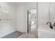 Modern bathroom featuring shower, vanity and view into living room area at 4840 Moon Rd, Powder Springs, GA 30127