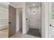 Modern glass shower with tile surround and pebble floor, located next to a well-organized walk-in closet at 4840 Moon Rd, Powder Springs, GA 30127