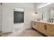 Bathroom featuring a herringbone cabinet, double sinks, and a marble tile floor at 4840 Moon Rd, Powder Springs, GA 30127