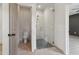 Modern glass shower with pebble floor, toilet, and neutral paint, with views into the bedroom at 4840 Moon Rd, Powder Springs, GA 30127