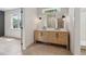 Bathroom showcasing a herringbone cabinet, double sinks, and a doorway that leads to a room at 4840 Moon Rd, Powder Springs, GA 30127