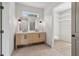Bright bathroom with a double sink vanity, neutral walls, and tile floors, plus a walk-in closet at 4840 Moon Rd, Powder Springs, GA 30127