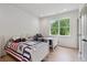 Bright bedroom featuring two twin beds, hardwood floors, and natural light from a window at 4840 Moon Rd, Powder Springs, GA 30127