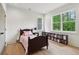 Cozy bedroom with a wood frame bed, natural light, and a bookcase filled with reading material at 4840 Moon Rd, Powder Springs, GA 30127