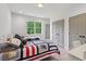 ' bedroom features two twin beds with matching sporty quilts and bright window at 4840 Moon Rd, Powder Springs, GA 30127