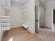 Organized walk-in closet with custom shelving, hanging rods, view into a bathroom with a glass shower at 4840 Moon Rd, Powder Springs, GA 30127
