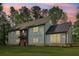 Stunning two-story home featuring a colorful front door, set against a beautiful twilight sky at 4840 Moon Rd, Powder Springs, GA 30127