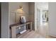 Bright foyer featuring decorative art, console table, gray walls, and light wood floors at 4840 Moon Rd, Powder Springs, GA 30127