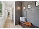 Inviting hallway with a wooden bench, neutral paint, and views of the exterior at 4840 Moon Rd, Powder Springs, GA 30127