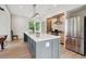 Bright kitchen with a large center island, modern light fixture, and stainless steel refrigerator at 4840 Moon Rd, Powder Springs, GA 30127
