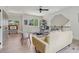 Bright living room features modern ceiling fan, light wood floors and neutral decor at 4840 Moon Rd, Powder Springs, GA 30127