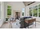 Bright living room with a brick fireplace, comfortable seating, and large windows offering beautiful outdoor views at 4840 Moon Rd, Powder Springs, GA 30127