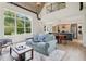 Bright, open-concept living room features a kitchen, dining area, and plenty of natural light from the large windows at 4840 Moon Rd, Powder Springs, GA 30127