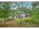 Secluded two-story home surrounded by mature trees and lush greenery at 4840 Moon Rd, Powder Springs, GA 30127