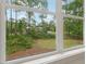 Enjoy stunning views of the backyard greenery and neighboring homes through this large, multi-pane window at 4840 Moon Rd, Powder Springs, GA 30127