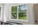 Picturesque view of lush green trees and distant buildings seen through a large, bright window at 4840 Moon Rd, Powder Springs, GA 30127
