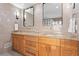 This bathroom has a double vanity with sleek cabinets, granite countertop and framed mirrors at 5148 Stratham Dr, Dunwoody, GA 30338