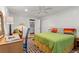 This bedroom offers a desk, chair, and a bed with colorful pillows and a green quilt at 5148 Stratham Dr, Dunwoody, GA 30338