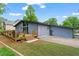 Exterior view showcases the home's deck, backyard and unique architectural design with contemporary lines at 5148 Stratham Dr, Dunwoody, GA 30338