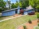 Aerial front exterior featuring the lawn, mature landscaping, and contemporary architectural design at 5148 Stratham Dr, Dunwoody, GA 30338