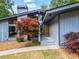 Charming home exterior featuring modern architecture, large windows, and a well-manicured front yard at 5148 Stratham Dr, Dunwoody, GA 30338