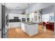 Contemporary kitchen with stainless appliances, white cabinets, black backsplash, and island at 5148 Stratham Dr, Dunwoody, GA 30338