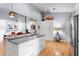 Bright and airy kitchen with white cabinets, stainless steel fridge, and spacious island at 5148 Stratham Dr, Dunwoody, GA 30338