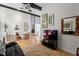 Open living space with cozy seating, hardwood floors, and large windows that offer plenty of natural light at 5148 Stratham Dr, Dunwoody, GA 30338