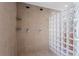The modern shower features dual showerheads, glass block accents, and built-in shelving at 5148 Stratham Dr, Dunwoody, GA 30338
