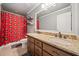 Bathroom featuring a double vanity with granite countertops, dark wood cabinets and red accents at 121 Harmony Oaks Trl, Canton, GA 30115