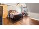 Bright bedroom with wood floors, ceiling fan, barn door, and lots of natural light at 121 Harmony Oaks Trl, Canton, GA 30115