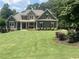 Charming two-story home with a manicured lawn and attractive stone and siding details at 121 Harmony Oaks Trl, Canton, GA 30115