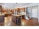 Spacious kitchen boasts wood cabinets, granite countertops, an island, and stainless steel appliances at 121 Harmony Oaks Trl, Canton, GA 30115