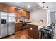 Kitchen featuring wooden cabinets, granite countertops, stainless appliances, and island with bar seating at 121 Harmony Oaks Trl, Canton, GA 30115