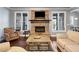 Bright living room featuring a stone fireplace, hardwood floors, and comfortable furnishings at 121 Harmony Oaks Trl, Canton, GA 30115