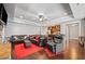 Finished basement living room featuring leather sofas, stone fireplace, and open access to bar area at 121 Harmony Oaks Trl, Canton, GA 30115
