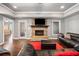 Finished basement living room with stone fireplace, modern lighting, and comfortable leather seating at 121 Harmony Oaks Trl, Canton, GA 30115