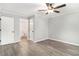 Bright bedroom with hardwood floors, ceiling fan, neutral paint, and ensuite bathroom at 2002 Country Park Se Dr, Smyrna, GA 30080
