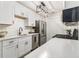 Modern kitchen featuring white cabinets, stainless steel appliances, and quartz countertops at 2002 Country Park Se Dr, Smyrna, GA 30080
