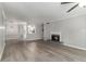 Spacious living room with a fireplace and hardwood floors that transitions to the kitchen at 2002 Country Park Se Dr, Smyrna, GA 30080