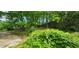 A serene backyard with lush greenery, mature trees, and a fence, providing a private and peaceful outdoor space at 2886 The Fontainebleau Sw, Atlanta, GA 30331