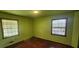 A bedroom featuring wood floors and two windows at 2886 The Fontainebleau Sw, Atlanta, GA 30331