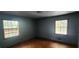 A bedroom featuring wood floors and two windows at 2886 The Fontainebleau Sw, Atlanta, GA 30331