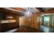 Open dining area with wood-paneled walls, a view of the kitchen, and convenient access to a tiled entryway at 2886 The Fontainebleau Sw, Atlanta, GA 30331